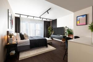 a bedroom with a bed and a living room at TurnKey I Central Apartment with Terrace in Prague