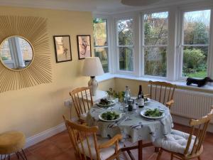 a dining room with a table with plates of food at Peaceful house ideal for dogs lovely location in Aldeburgh