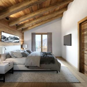 a bedroom with a white bed and wooden ceilings at Odalys Chalet Sporting Lodge in Plagne 1800