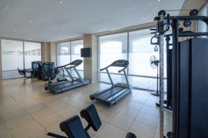 a gym with several tread machines in a room at NH Gran Hotel Provincial in Mar del Plata