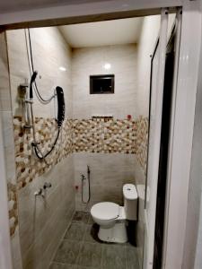 a small bathroom with a toilet and a shower at MINI HOTEL CONCEPT in Kuala Terengganu
