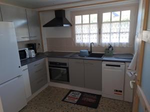 a kitchen with a sink and a stove top oven at JOLI DEUX PIECES PROCHES TOUTES COMMODITES à CHALLANS in Challans