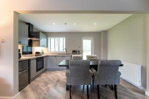 a kitchen with a dining room table and chairs at 33 Dunbar Court Gleneagles Village in Auchterarder