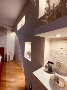 a room with a staircase and a wall with paintings at Serendipity in Bentivoglio +30 photos