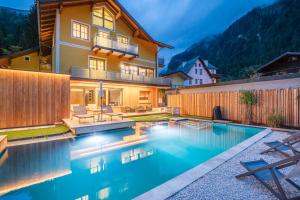 a house with a swimming pool in the backyard at Appartementhaus zur Post in Bad Gastein