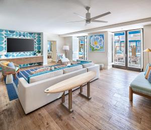 a living room with a couch and a tv at Margaritaville Hotel San Diego Gaslamp Quarter in San Diego