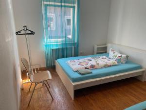 1 dormitorio pequeño con 1 cama y 1 silla en Apartament mit Schlafzimmer en Hugsweier