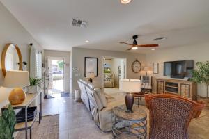 a living room with a couch and a table at Maricopa Retreat with Peaceful Backyard Oasis! in Maricopa