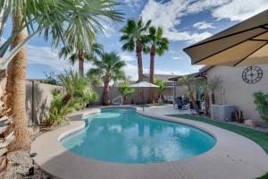 a swimming pool with palm trees in a yard at Maricopa Retreat with Peaceful Backyard Oasis! in Maricopa