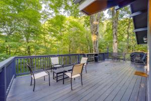 a deck with chairs and tables and trees at Pristine Cabin Less Than 2 Mi to Beech Mountain Resort! in Beech Mountain