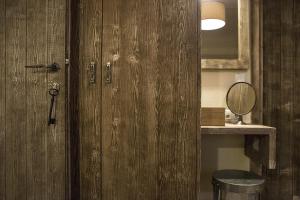 a wooden door in a room with a stool at Kalderimi Country House in Mouresi +166 photos