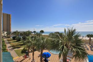 a view of a resort with palm trees and the beach at The Summit by Panhandle Getaways in Panama City Beach