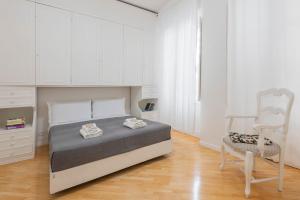 Ένα ή περισσότερα κρεβάτια σε δωμάτιο στο Colosseum Flat - Zen Real Estate