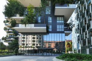 an apartment building with plants on the facade at Luxury Suite in Bosco Verticale Milano Isola in Milan