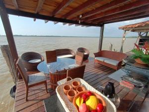 a table with a bowl of fruit on a boat at ILHA DA FANTASIA in Belém