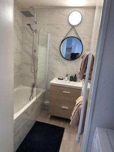 a bathroom with a shower and a sink and a mirror at Le venizio Sète in Sète