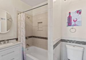 a bathroom with a shower and a toilet and a sink at Newly Renovated Guest Rooms near Transportation in Philadelphia