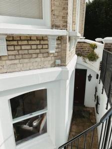 a white fireplace on the side of a house at Stunning Victorian Mansion Flat in Brighton & Hove