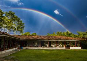 a rainbow in the sky above a house at Villa Cristina - Casa Boutique in Pereira
