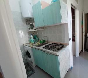 a small kitchen with a stove and a sink at Casa Sonia in Ischia