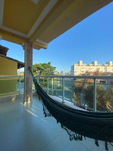 a hammock on the balcony of a building at Casa do Mar Stella Maris in Salvador