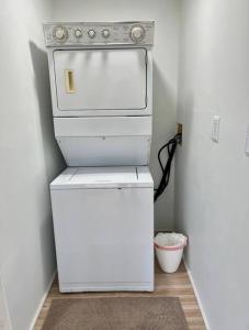 a small refrigerator in a room with a white refrigerator freezer at In the Center of Gulfport, Min Away From the Beach! in St Petersburg