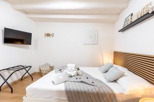 a bedroom with a bed with a laptop on it at Dimora Pastini in Rome