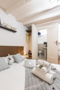 a bedroom with a white bed with a laptop on it at Dimora Pastini in Rome