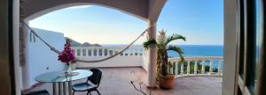 a room with a balcony with a view of the ocean at Best ocean view 1 bedroom long term opportunity in Las Flores