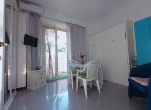 ein Wohnzimmer mit einem Tisch, Stühlen und einem Sofa in der Unterkunft Casa Sonia in Ischia