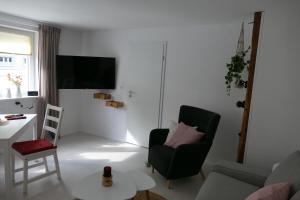a living room with a couch and a chair at Harzapart Appartement 1 Pferdchen in Walkenried