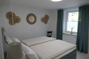 a bedroom with a white bed and a window at Harzapart Appartement 1 Pferdchen in Walkenried