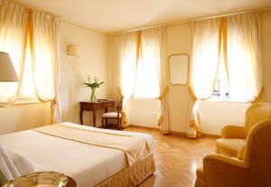 Postel nebo postele na pokoji v ubytování La Vittoria Rooms & Suites