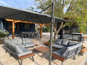 a patio with couches and an umbrella at El Refugio de Haro in Haro