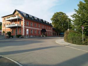 a large red building on the side of a street at Ehem. Sächsisch-Bayrischer Hof in Pöhl