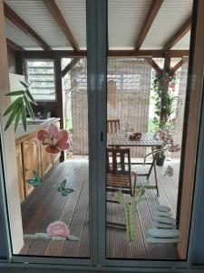 a sliding glass door of a patio with a table at Studio Perle de Zanzibar Trois-Ilets in Les Trois-Îlets