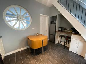 a kitchen with a wooden table and a window at Cosy and Comfortable Newly Refurbished Family Home in Hull