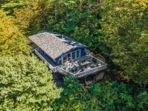 an aerial view of a house in the middle of a forest at Dog friendly Family home at Lake Winnipesaukee & Gunstock in Gilford