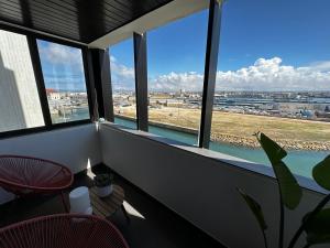 a balcony with windows and a view of a city at Ponte Velha in Peniche