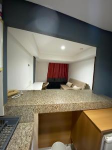 a kitchen with a counter top and a living room at Marinas Flat 116 in João Pessoa +18 photos