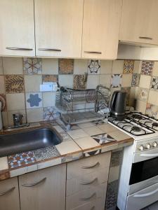 a kitchen with a sink and a stove at La China in Neuquén