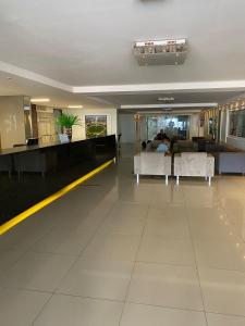 a large room with a lobby with couches at Marinas Flat 116 in João Pessoa