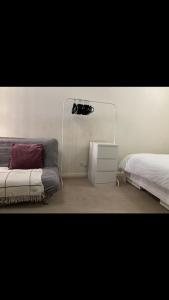 a bedroom with two beds and a dresser and a lamp at Cosy central London flat Trafalgar Square in London