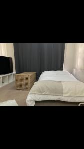 a bedroom with a bed and a flat screen tv at Cosy central London flat Trafalgar Square in London