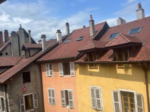 a group of buildings with red roofs at L'escalier du Château T4 Duplex 9 couchages 4* in Annecy