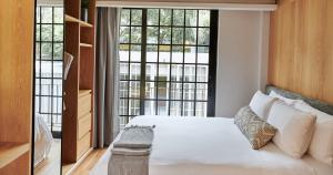 a bedroom with a bed and a large window at Casa Izeba in Mexico City
