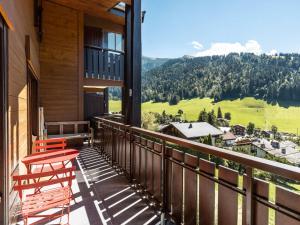 a balcony with two chairs and a view of the mountains at Appartement La Clusaz, 6 pièces, 7 personnes - FR-1-304-175 in La Clusaz