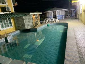 a swimming pool at night with a green tiled floor at 1 Bed Villa - Sleeps 4 - Pool - Parking - Wifi in Georgetown +4 photos