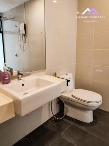 a bathroom with a sink and a toilet and a mirror at Mosaic Southkey Midvelly By Elegant Johor Bahru in Johor Bahru