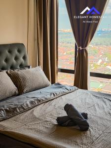 a bed in a room with a large window at Mosaic Southkey Midvelly By Elegant Johor Bahru in Johor Bahru
